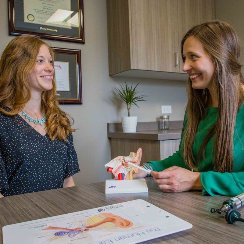 audiologist talking to a patient